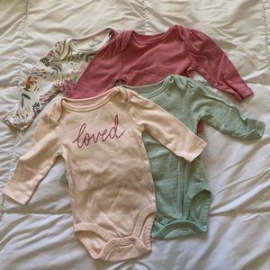 Four pack of Cloud Island long sleeve baby girl onesies